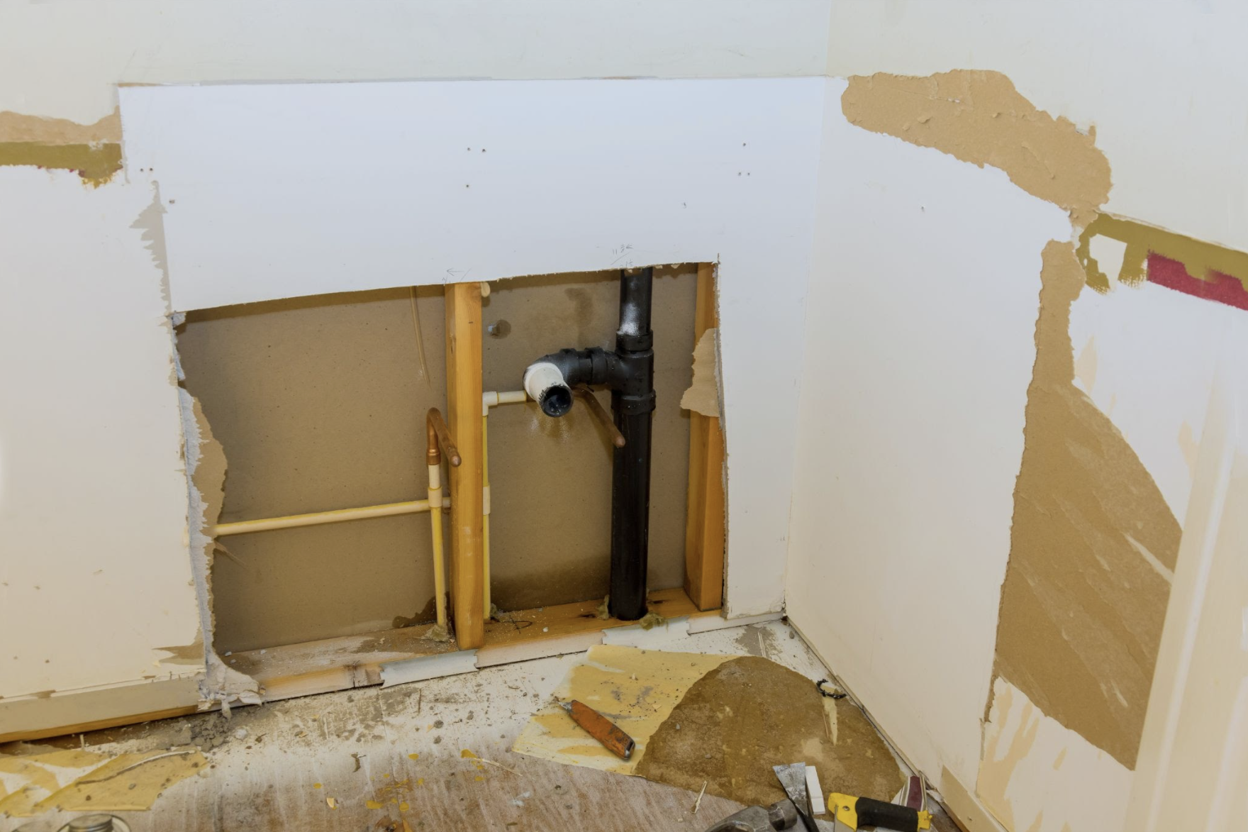 Water damage from pipe leak behind a wall