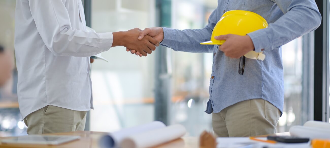 Architect and contractor shake hands