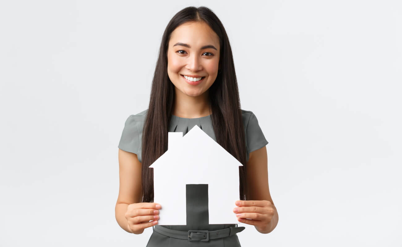 Woman holding model of house