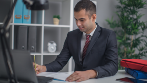 A public adjuster signing papers