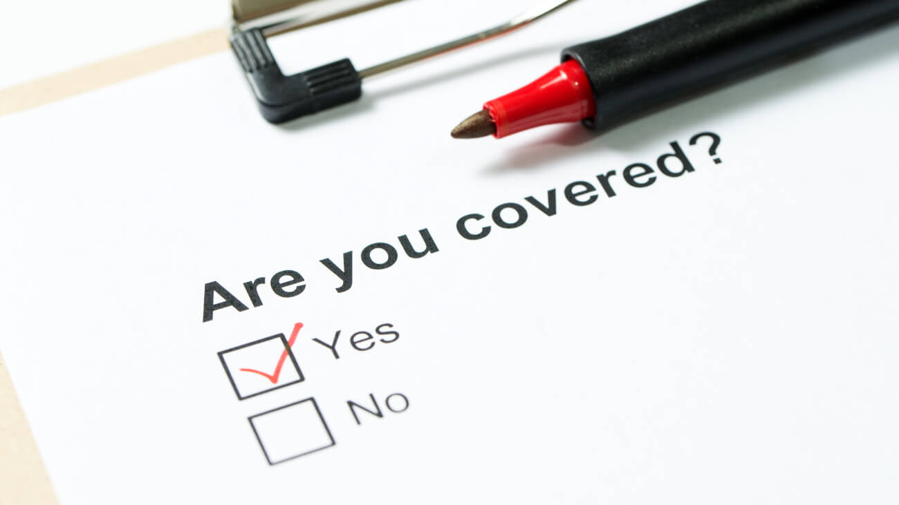 Paper with the words “Are you covered” with a red tick mark in the Yes block.