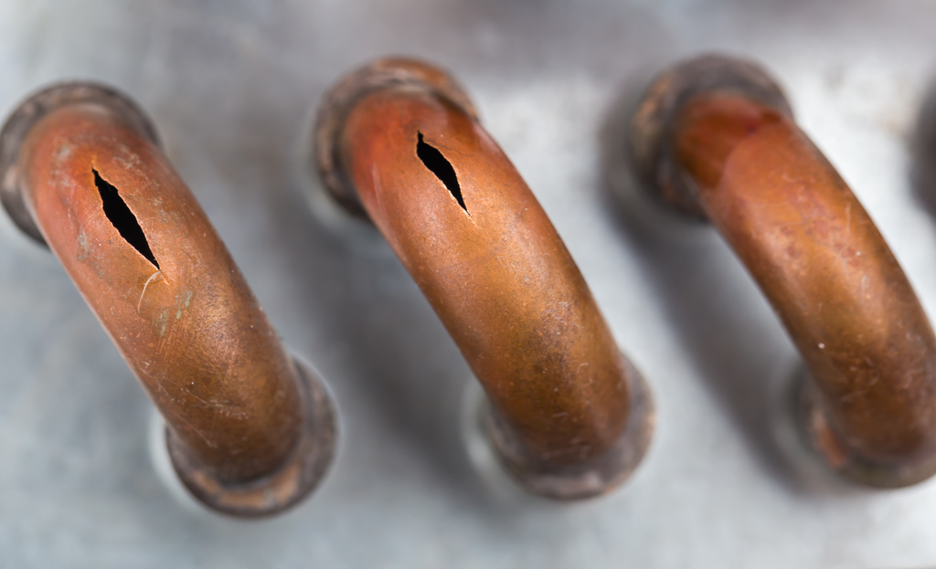close-up of a burst pipe causing water damage