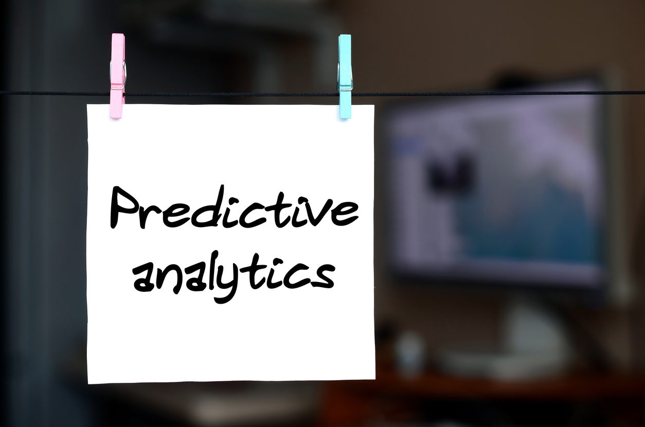 two wooden figures are stacked on top of each other with the word predictive analytics