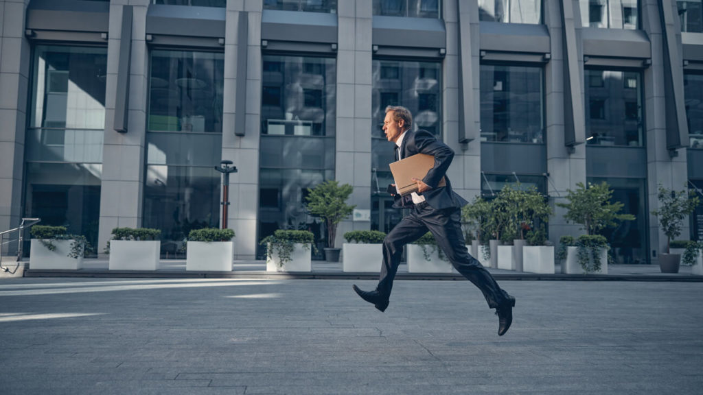 Businessman running fast on the street