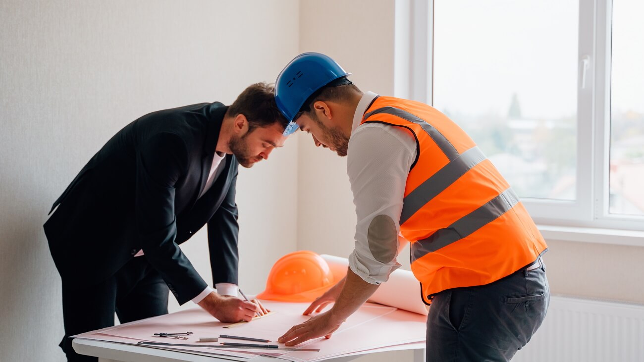 Insurance adjuster and contractor looking over plans