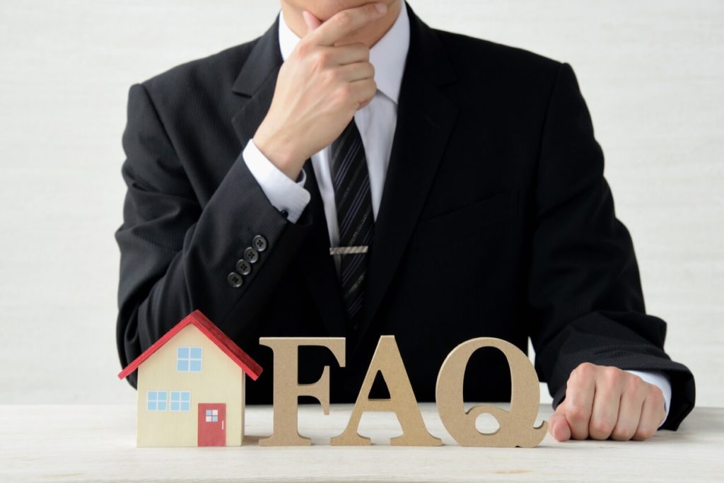Businessman with house and FAQ objects about insurance claims