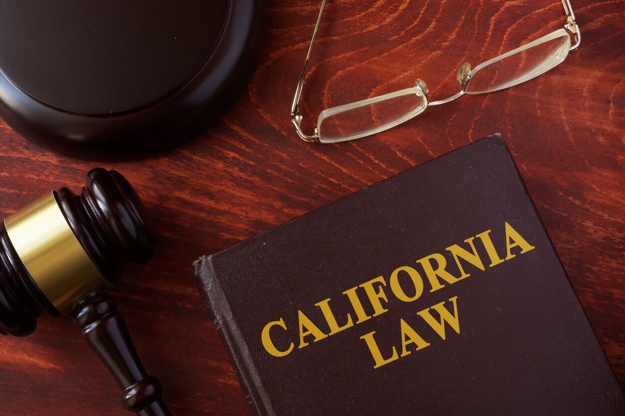 Book with title California Law and a judges gavel and block