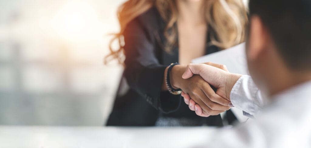 Public adjuster in long beach handshake with woman with long fair hair