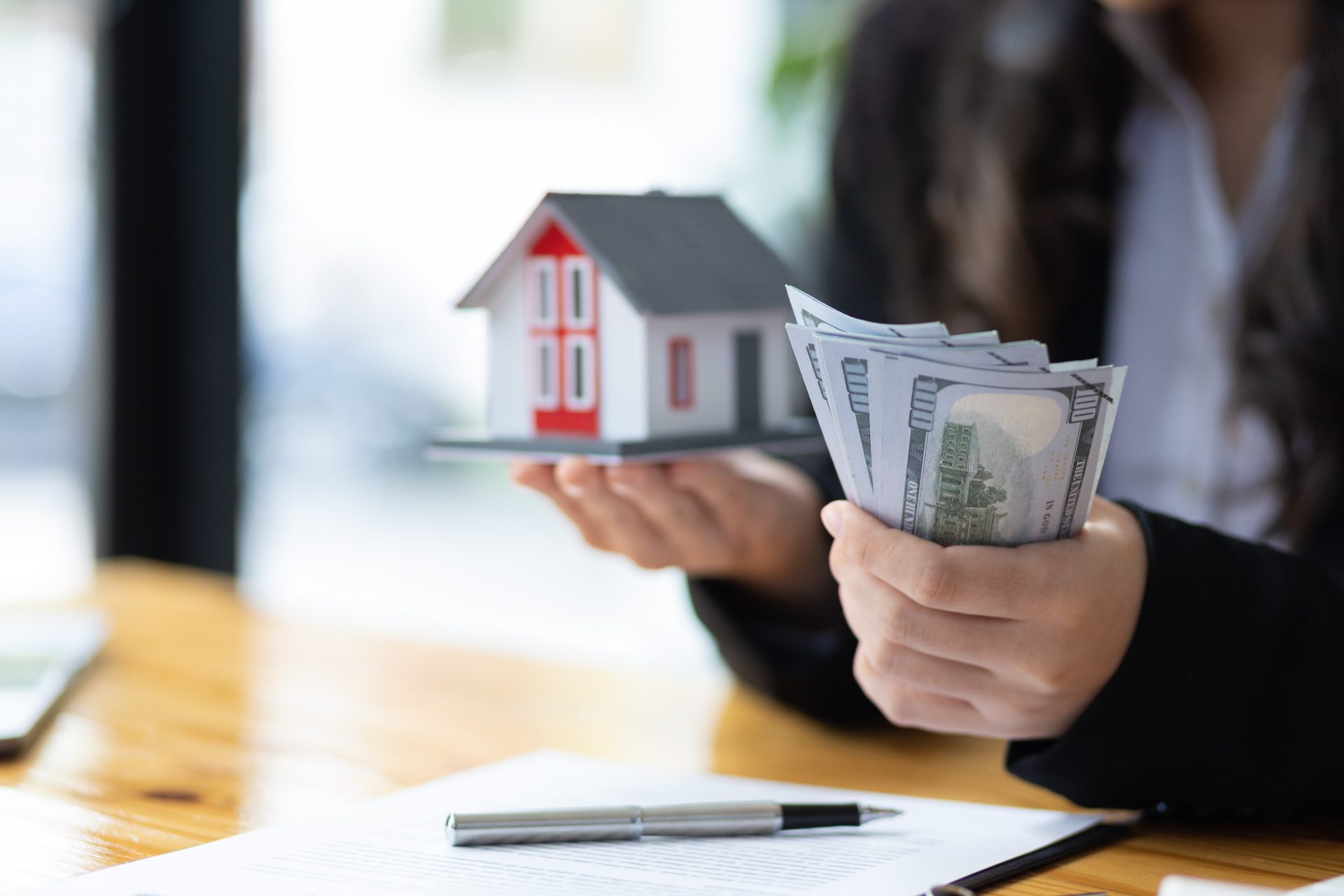 A professional holding money indicating the actual cash value of a claim